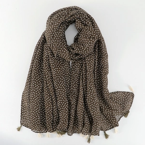 Close-up of vintage brown floral scarf with delicate white flowers and olive green tassels
