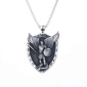 Detailed close-up of silver St. Michael angel warrior shield pendant with cross and chain
