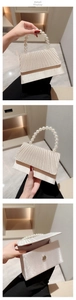 Detail view of cream satin evening bag with pearl handle and pleated foldover flap