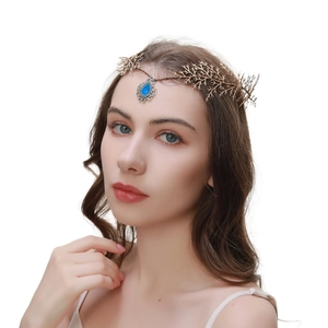 Detailed view of a gold leaf branch headband featuring a central blue gemstone on forehead