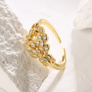Detailed macro view of 18K gold-plated leaf ring with shimmering white zircon stones