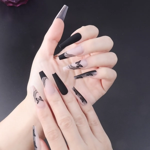Matte black butterfly line art long ballerina press-on nails on a hand model