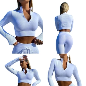 White ribbed two-piece activewear set featuring a quarter-zip crop top and leggings