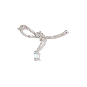 Macro shot of silver knot necklace pendant with clear round and baguette zircon stones
