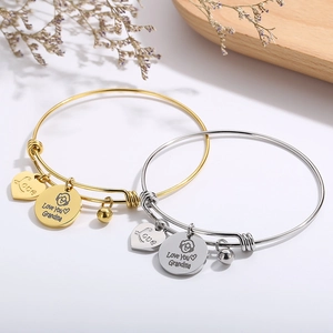 Adjustable wire bracelet with heart and Grandma charms in gold and silver finish