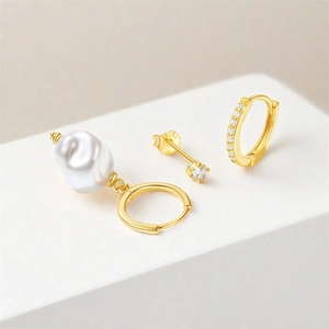 Detailed shot of S925 silver gold-plated jewelry set with baroque pearl and turquoise stones