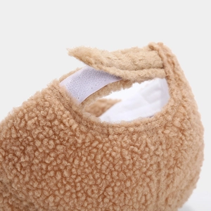 Detailed macro view of camel fleece baseball cap with adjustable white velcro closure