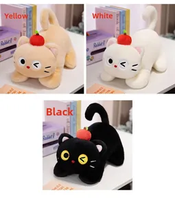 Three colors of plush cat toys with red apple on head in a cozy home setting