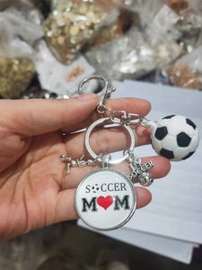 Macro shot of metal soccer keychain featuring Soccer Mom charms and athlete silhouette