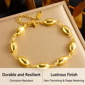 Close-up of golden stainless steel oval bead chain bracelet on a leather jewelry box