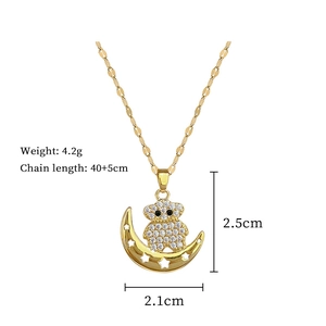 Detail view of gold bear on moon pendant with dimensions 2.5cm by 2.1cm and 4.2g weight