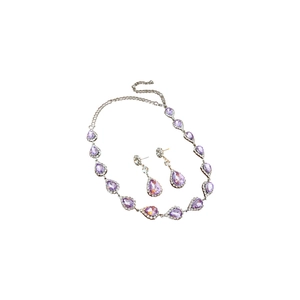 Elegant silver necklace and earrings set with purple teardrop crystals and clear rhinestones