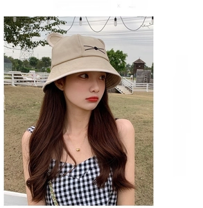 Close-up of beige sun hat featuring cute 3D cat ears and black whisker embroidery detail