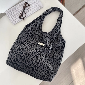 Close-up of leopard print tote bag with Sozahka brand label on corduroy fabric surface
