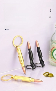 Detailed view of bullet-shaped bottle opener keychain in black and gold zinc alloy