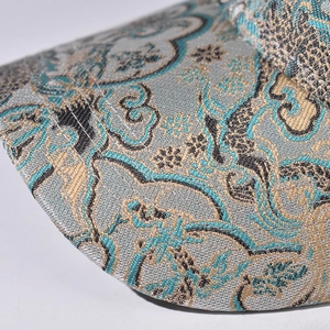 Macro view of Chinese jacquard patterns and gold stitching on the baseball cap brim
