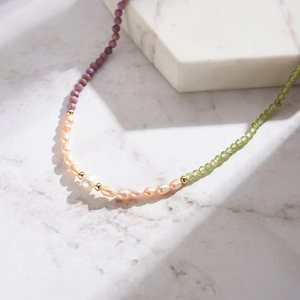 Detail of S925 silver necklace with purple mica, freshwater pearls, and peridot stones