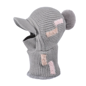Winter gray knitted balaclava with warm faux fur pompom and colorful plush patches