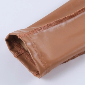 Detail of tan PU leather jacket cuff showing precision stitching and material texture
