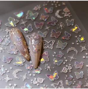 Macro shot of laser holographic butterfly and star nail art stickers with 3D effect