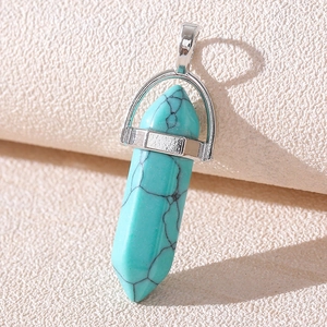 Macro shot of turquoise hexagonal prism pendant with a polished silver metal bail