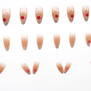Faux ongles amande dégradé nude French Ombré avec motifs étoiles rouges vifs