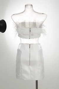 Detailed back view of white satin two-piece set with ostrich feathers and zippers