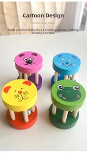 Close-up of four colorful wooden hand bells featuring cute cartoon animal faces for toddlers