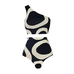 Detailed flat lay of a one-shoulder high-waisted bikini with black and cream abstract print