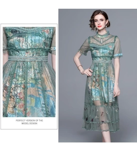 Detail of green mesh dress featuring exquisite floral embroidery and sequin beadwork