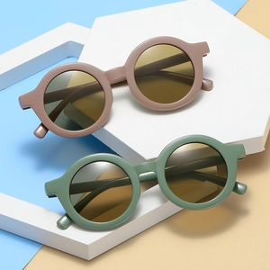 Fashionable round frame kids sunglasses in brown and green with UV protection