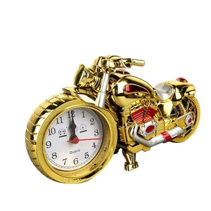 Golden motorcycle shaped alarm clock with quartz movement on a clean white background