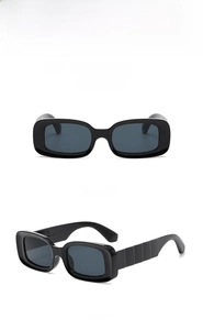 Detail view of black rectangular sunglasses featuring textured temples and dark lenses