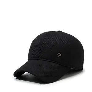 Detail of winter baseball cap with thick textured fabric and square metal logo accent