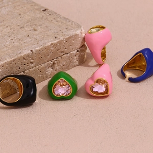 Detail of five 18K gold plated heart gemstone rings with colorful enamel finishes