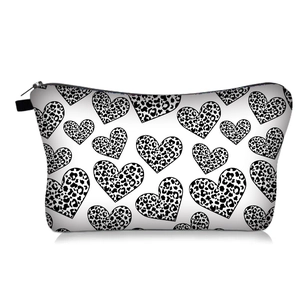 Portable cosmetic bag with black and white leopard heart print and top zipper closure