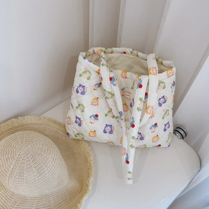 Detailed interior of a floral quilted cotton tote bag with cute cartoon prints