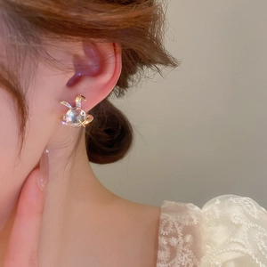 Cute bunny star resin earring with gold plating and zircons shown on a model