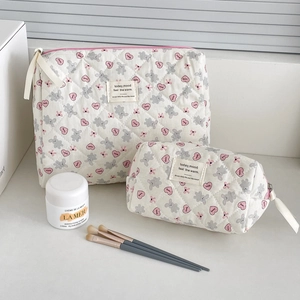 Detail of quilted bunny cosmetic bags showing heart prints and secure zipper closure