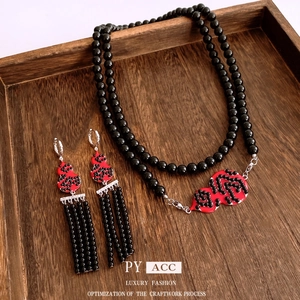 Vintage style jewelry set with red gourd pendants, black beaded necklace and earrings
