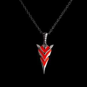Detailed view of a silver arrow pendant necklace with vibrant orange V-shaped accents