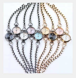 Collection of women's quartz watches with heart-shaped metal link straps and colored dials
