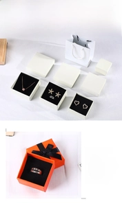 Orange jewelry box set with black bow and matching carrier bag for rings and earrings