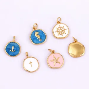 Macro detail of marine themed DIY jewelry pendants with gold plating and drip oil finish