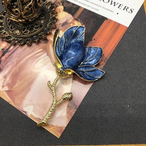 Elegant pastoral blue enamel magnolia flower brooch with a gold-plated frame and stem