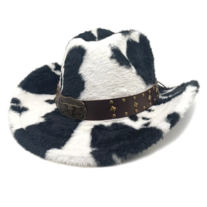 Detail of western cow print felt hat with leather band and vintage metal bull skull buckle