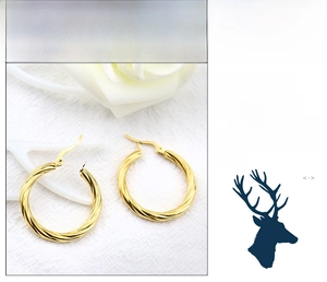 Close-up of twisted rope gold hoop earrings with polished mirror finish and stud closure