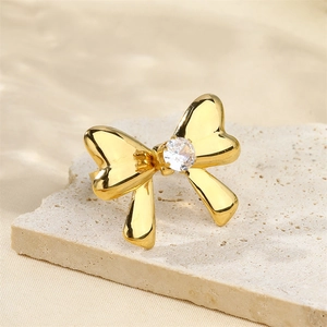 18K gold plated stainless steel bow ring with clear zircon on a stone pedestal