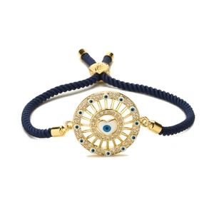 Adjustable evil eye braided bracelet with blue heart charm and gold-plated details