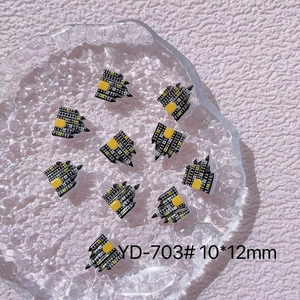 Macro detail of 10x12mm resin Halloween castle nail art charms in black and yellow